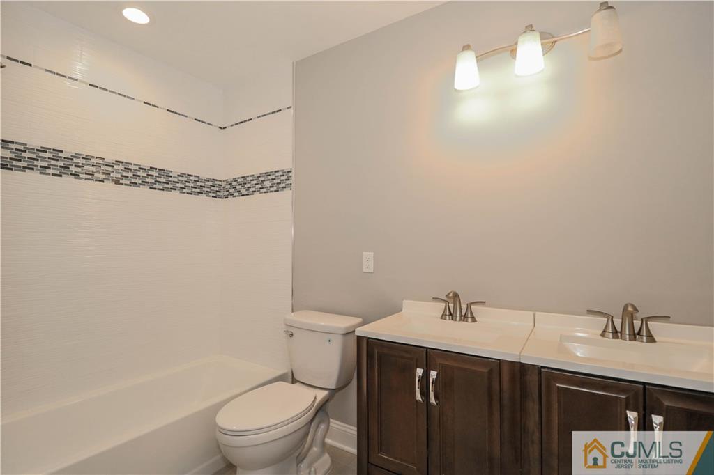 32 Windsor Road Edison, NJ 08817 - Photo 22 of 24 a bathroom with a sink vanity mirror and toilet