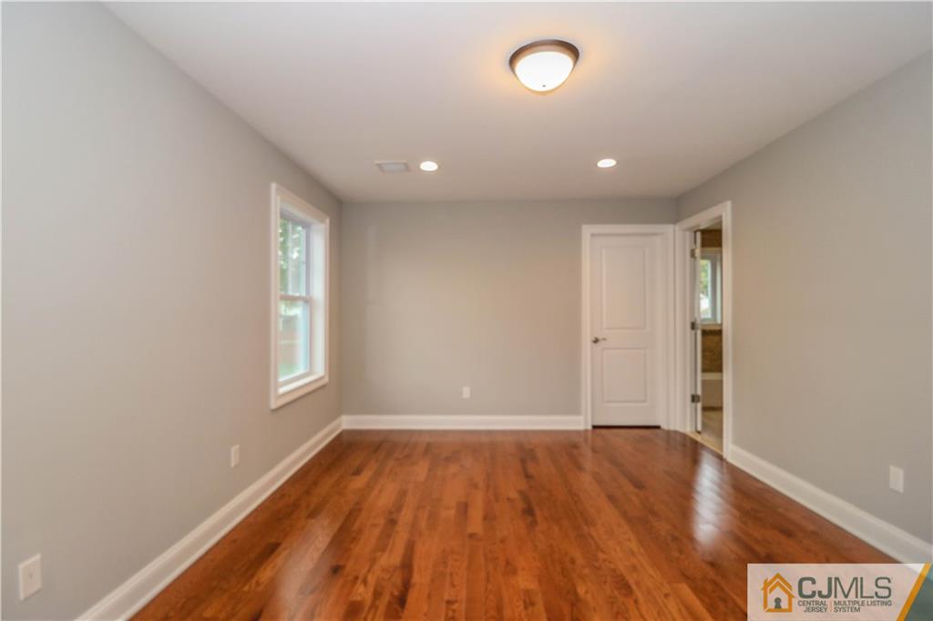 32 Windsor Road Edison, NJ 08817 - Photo 23 of 24 an empty room with wooden floor and windows