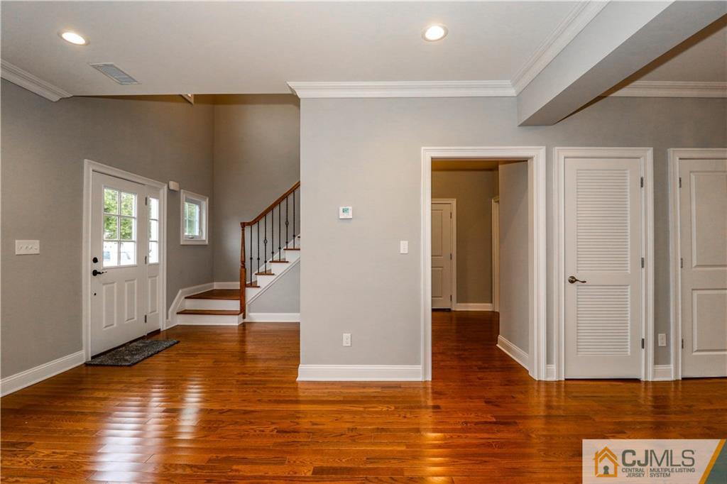 32 Windsor Road Edison, NJ 08817 - Photo 6 of 24 a view of empty room with wooden floor and fan