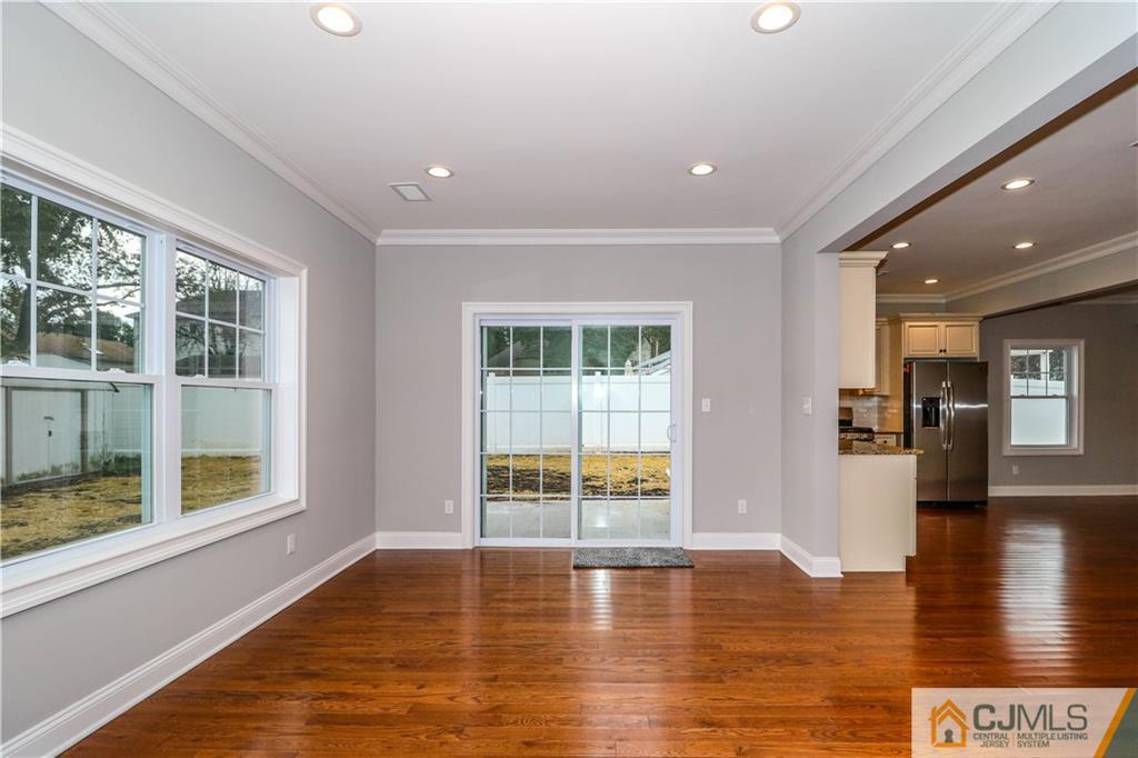 32 Windsor Road Edison, NJ 08817 - Photo 8 of 24 a view of an empty room with wooden floor and a window