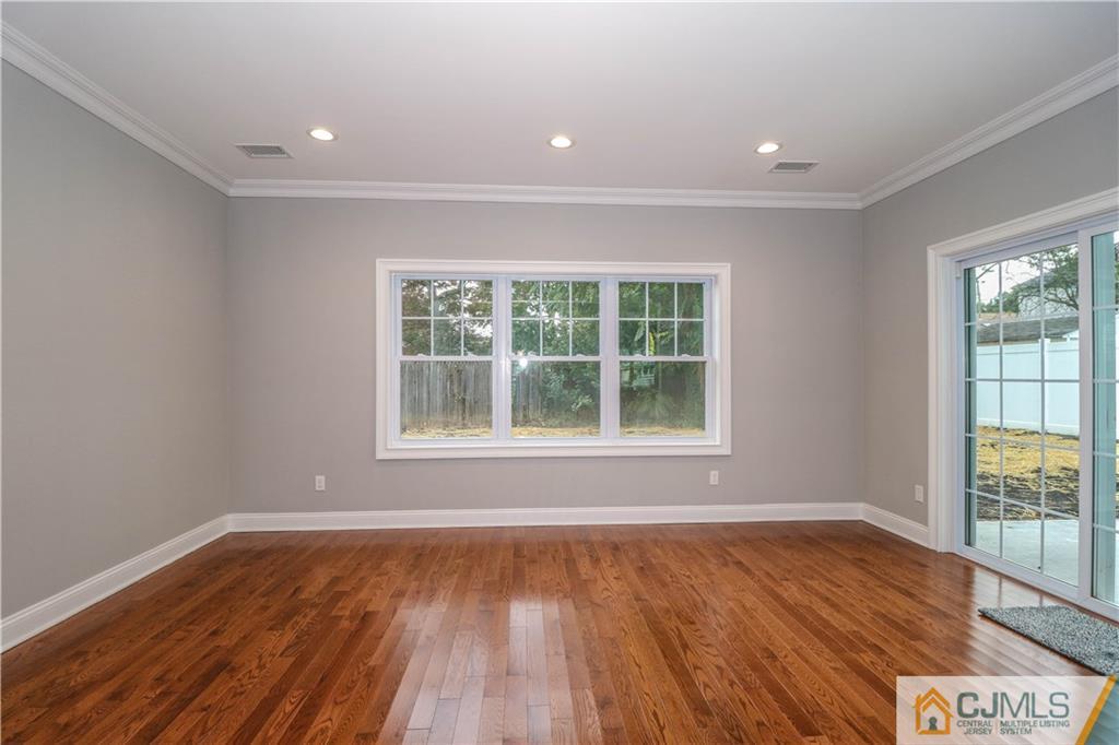 32 Windsor Road Edison, NJ 08817 - Photo 9 of 24 a view of an empty room with wooden floor and a window