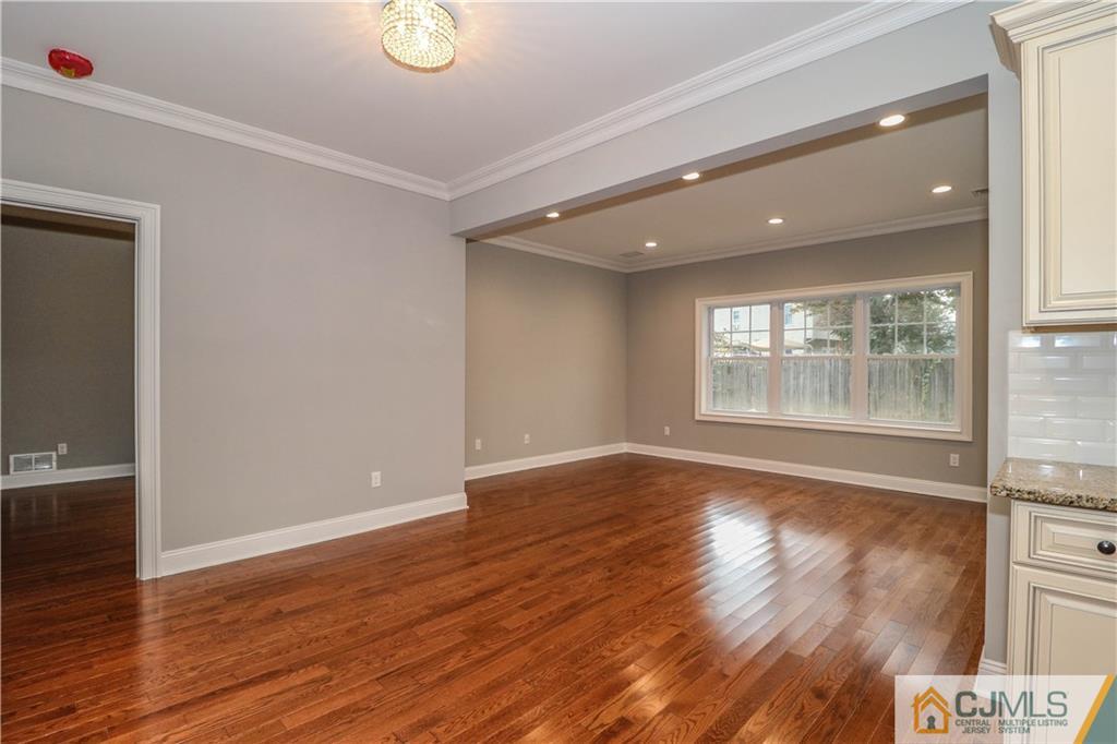 32 Windsor Road Edison, NJ 08817 - Photo 10 of 24 a view of an empty room with wooden floor and a window