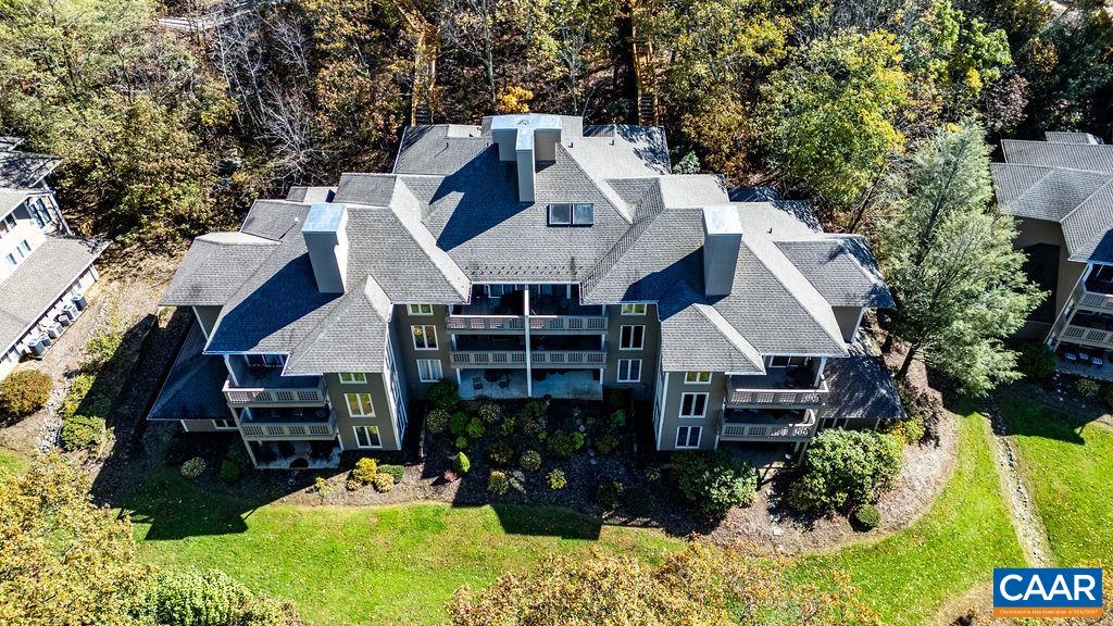 an aerial view of a house with a yard and balcony