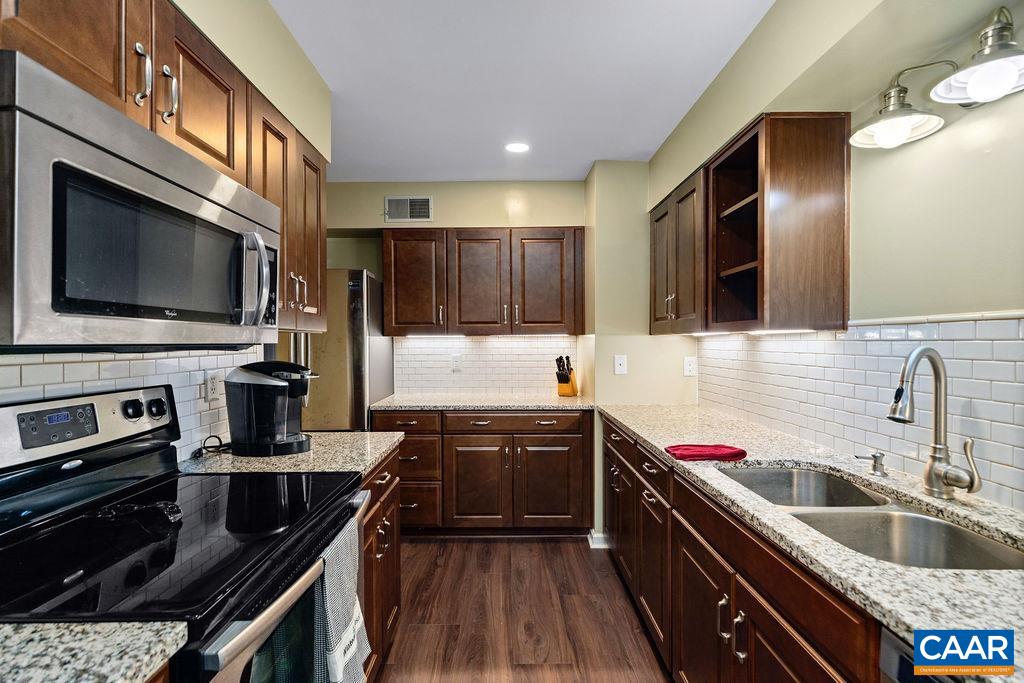 2048 Stone Ridge Wintergreen, VA 22967 - Photo 11 of 36 a kitchen with stainless steel appliances granite countertop a sink stove and refrigerator