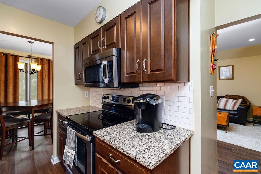 2048 Stone Ridge Wintergreen, VA 22967 - Photo 15 of 36 a kitchen with granite countertop kitchen island stainless steel appliances a sink stove and microwave