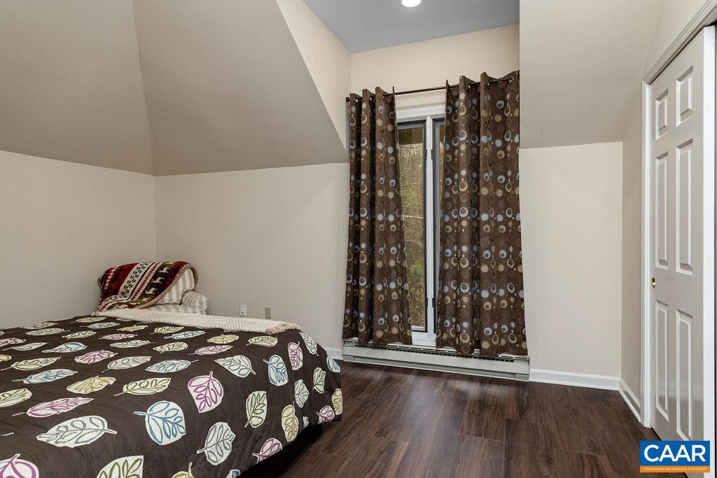 2048 Stone Ridge Wintergreen, VA 22967 - Photo 16 of 36 a bedroom with a bed and a wooden floor