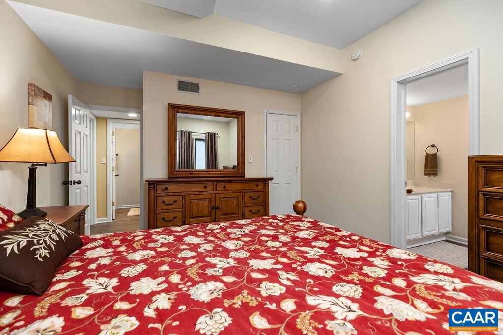 2048 Stone Ridge Wintergreen, VA 22967 - Photo 21 of 36 a bedroom with a large bed and a chandelier