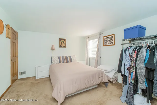 a bedroom with a bed and a walk in closet