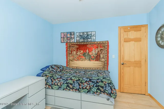 a room with a rug and a painting on the wall