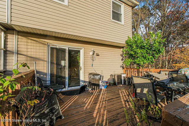 a view of a patio with table and chairs and potted plants