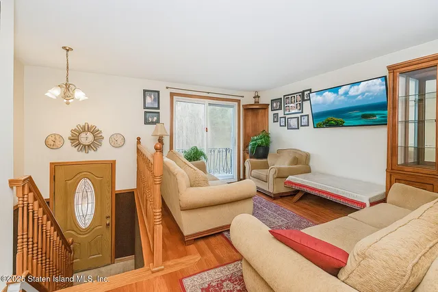 a living room with furniture a rug and a window