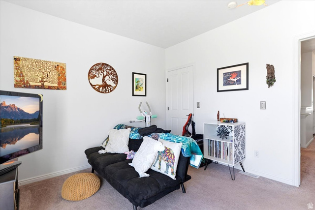 161 25th Street, Unit 6B Ogden, UT 84401 - Photo 14 of 20 Carpeted interior room featuring white walls and a white interior door with black hardware