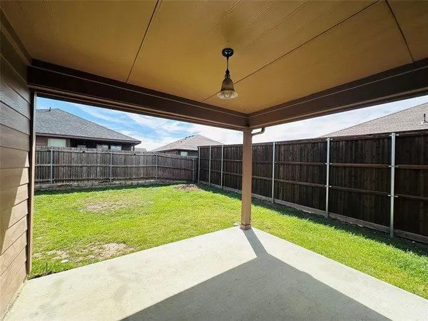 a view of a backyard with table and chairs