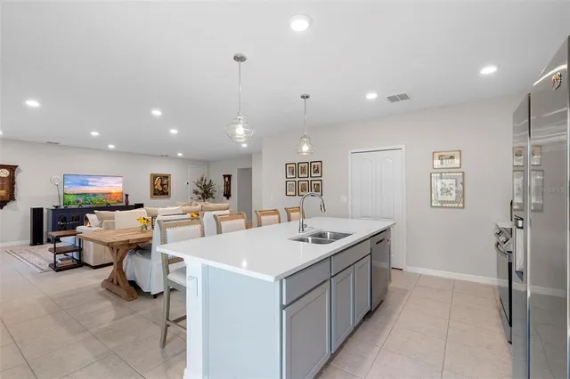 a kitchen with a sink and white cabinets