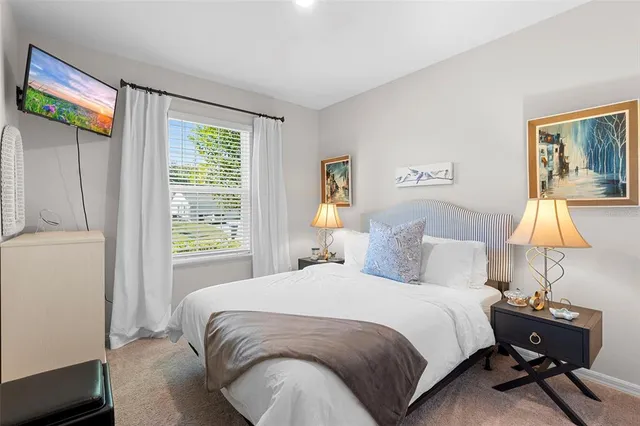 a bedroom with a bed and a lamp