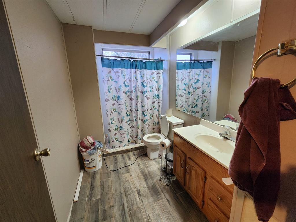 505 County Road 1442 Yantis, TX 75497 - Photo 13 of 19 a bathroom with a sink toilet and shower