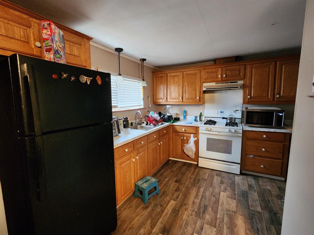 505 County Road 1442 Yantis, TX 75497 - Photo 8 of 19 a kitchen with granite countertop a refrigerator stove top oven and sink