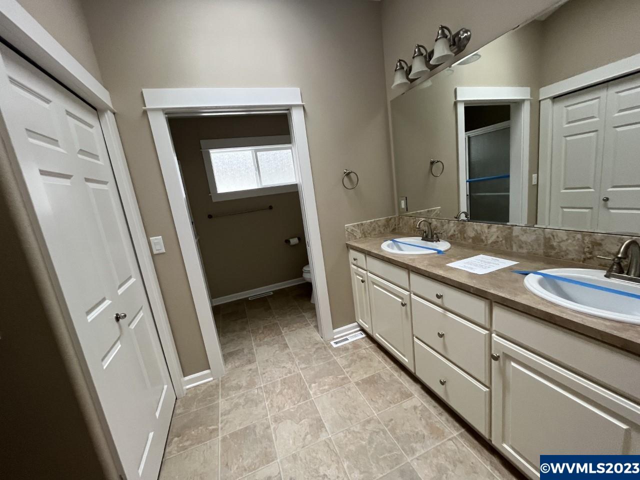 2152 Southeast Rhododendron Avenue Dallas, OR 97338 - Photo 10 of 16 a bathroom with a double vanity sink and mirror