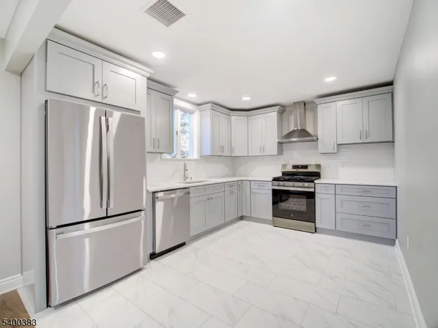 a view of a kitchen with a sink and a refrigerator