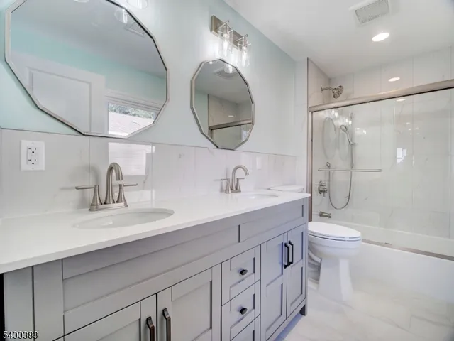 a bathroom with a shower a toilet and sink