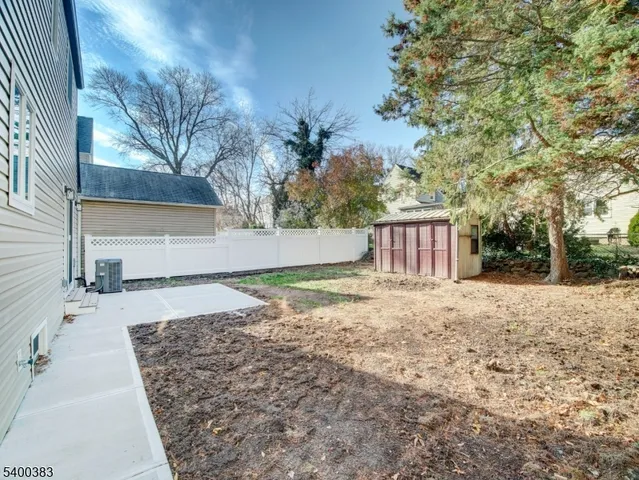 a view of a backyard with large trees