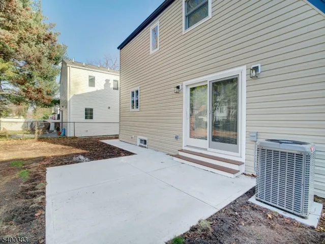 a view of a house with backyard and trees