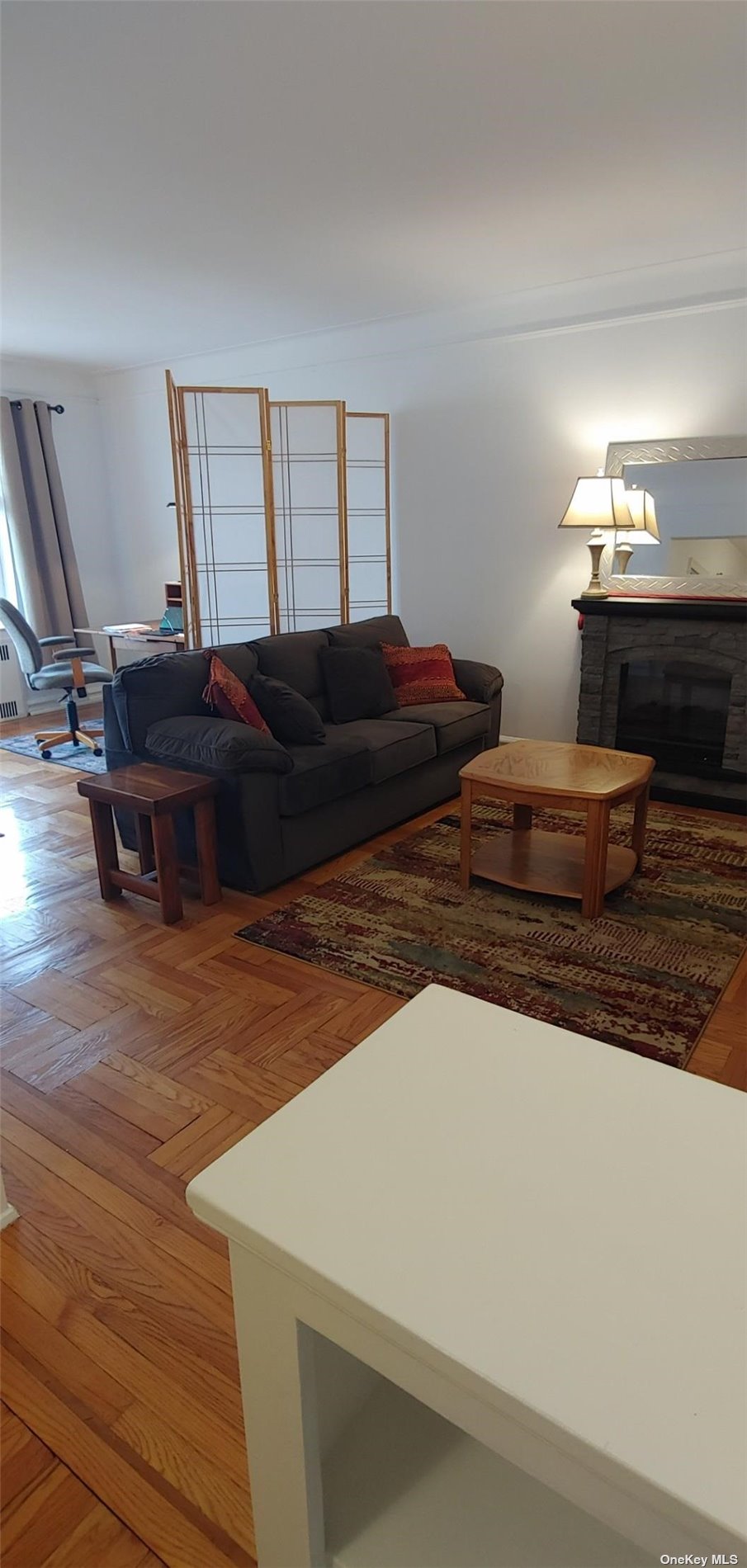 a living room with hard wood flooring and a couch