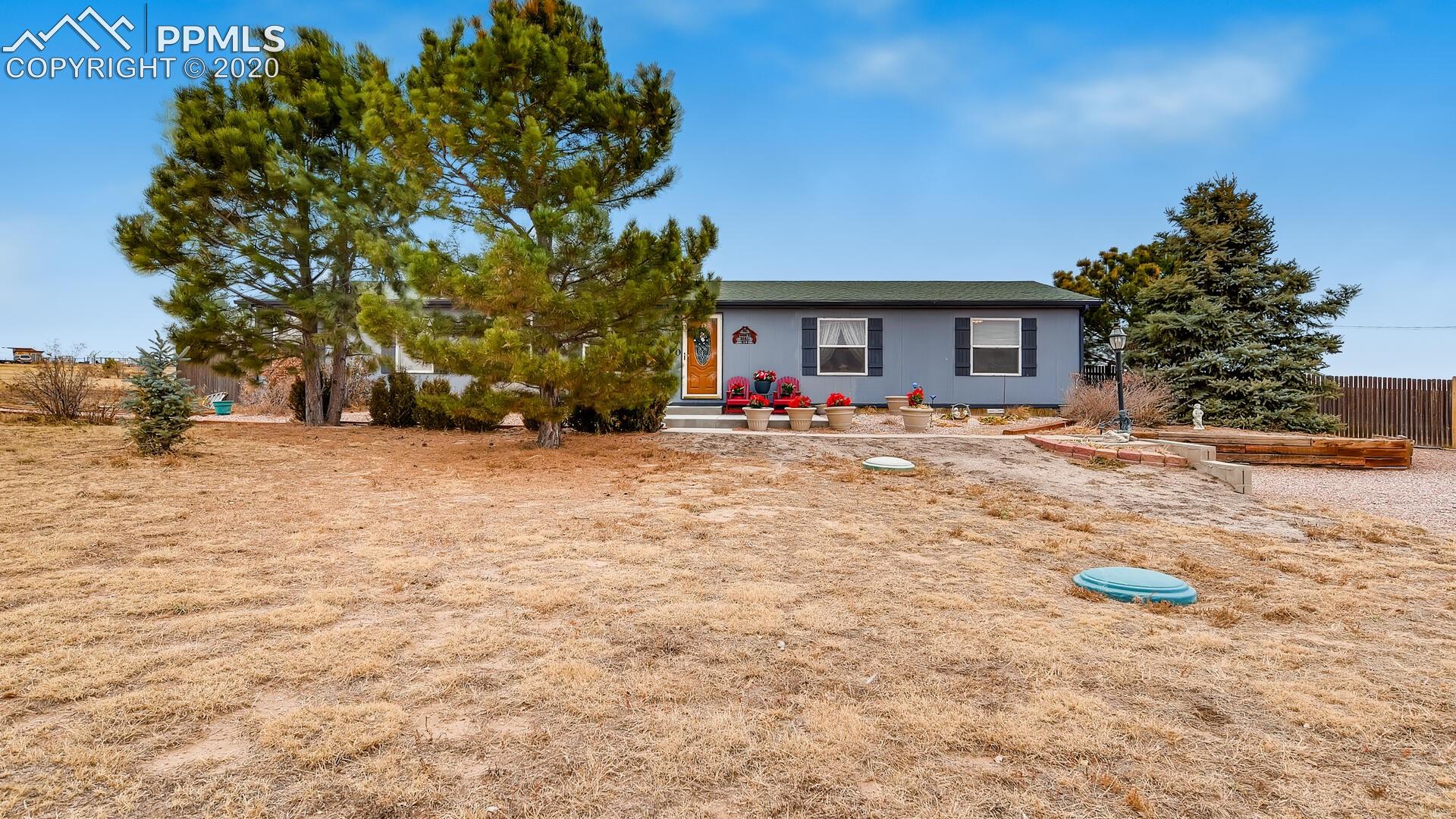 17570 Sage Crest Road Peyton, CO 80831 - Photo 1 of 25 Peaceful setting. Rancher behind the towering pines.