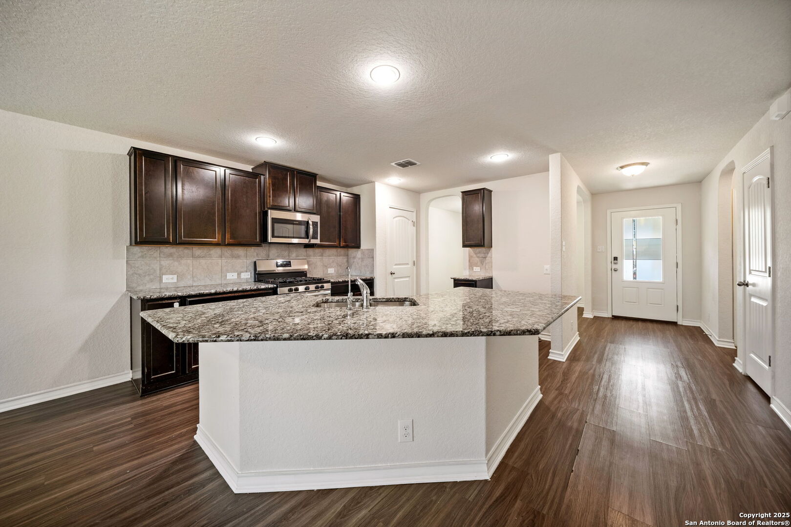 13415 Wild Rye San Antonio, TX 78254 - Photo 11 of 49 a kitchen with granite countertop a sink and refrigerator