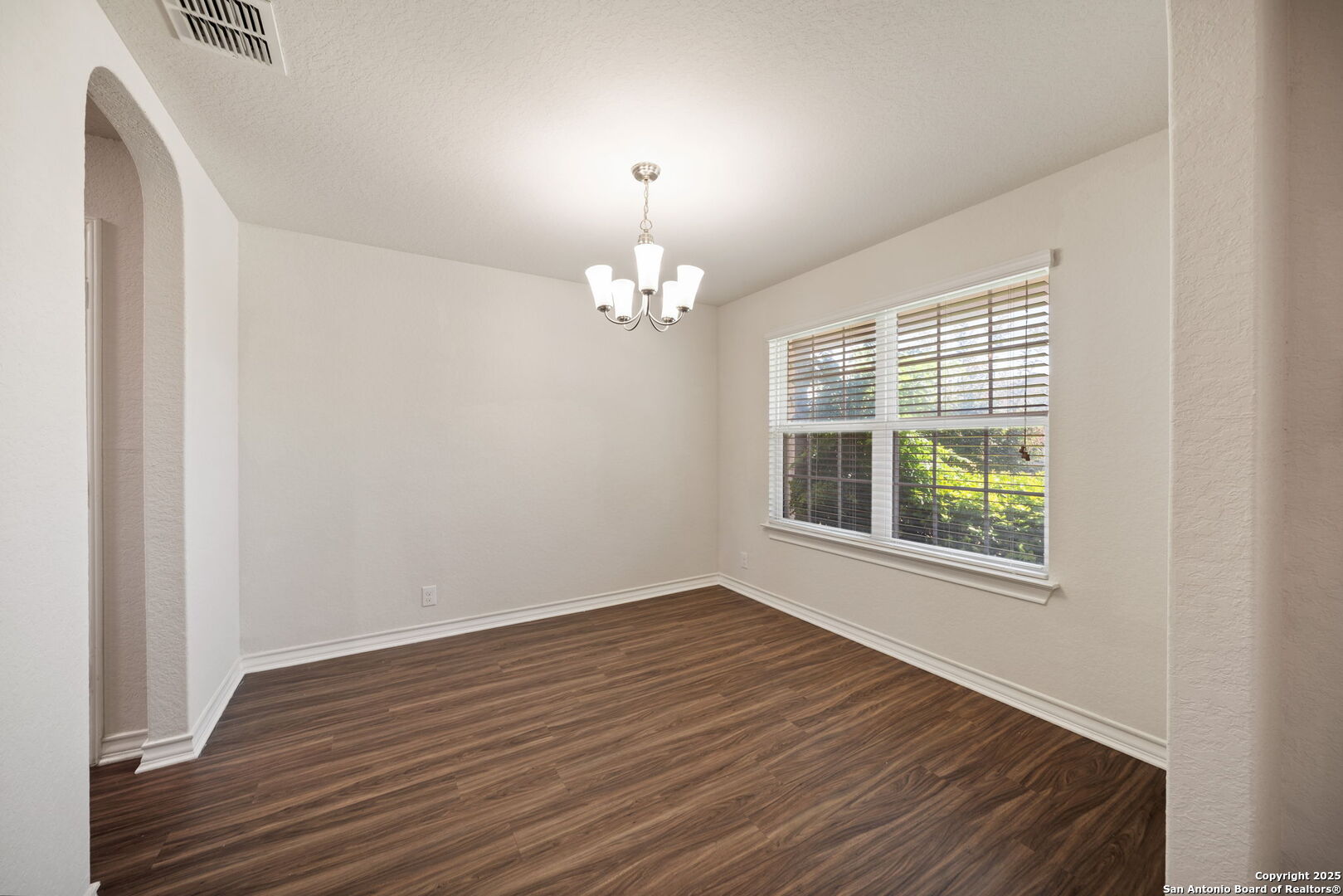 13415 Wild Rye San Antonio, TX 78254 - Photo 12 of 49 a view of an empty room with wooden floor and a window