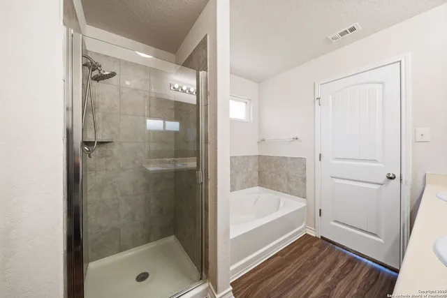 a bathroom with a bathtub and a shower