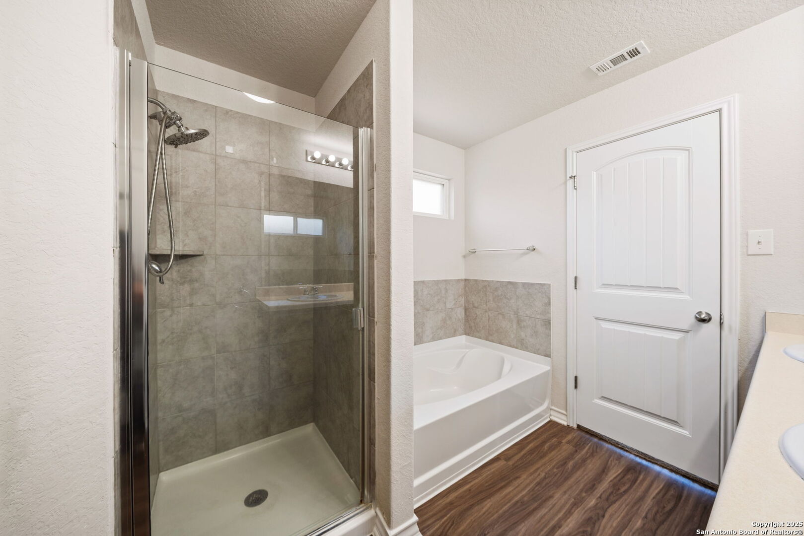 13415 Wild Rye San Antonio, TX 78254 - Photo 20 of 49 a bathroom with a bathtub and a shower