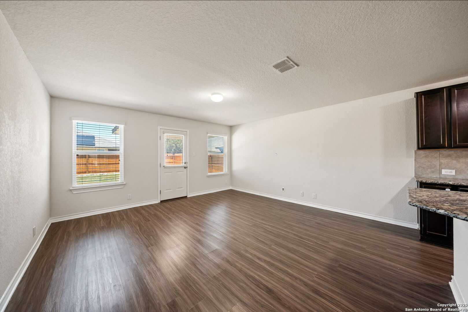 13415 Wild Rye San Antonio, TX 78254 - Photo 6 of 49 a view of an empty room with window and wooden floor