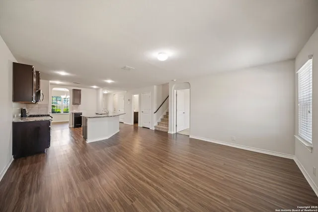 a view of kitchen view wooden floor and kitchen view