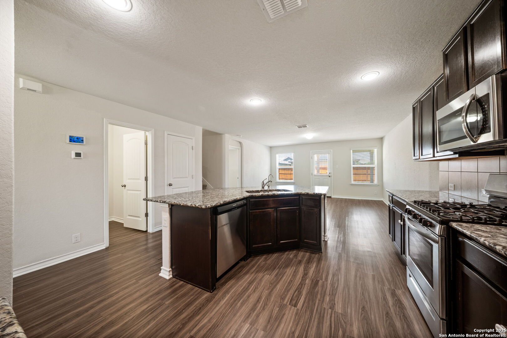 13415 Wild Rye San Antonio, TX 78254 - Photo 9 of 49 a kitchen with stainless steel appliances granite countertop a stove and cabinets