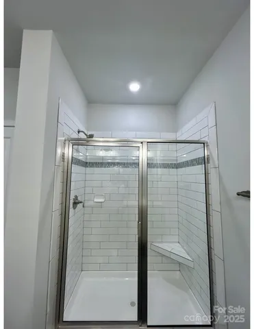 a bathroom with a glass shower door