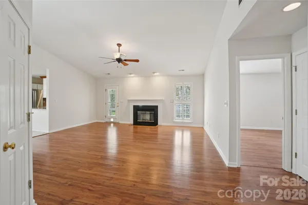 wooden floor in an empty room with a fireplace
