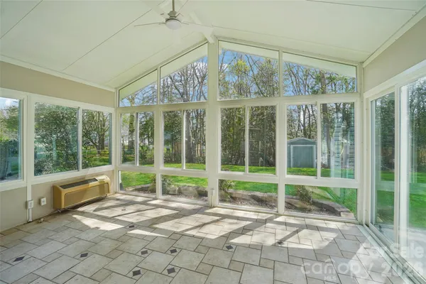 a view of empty room with floor to ceiling windows and yard