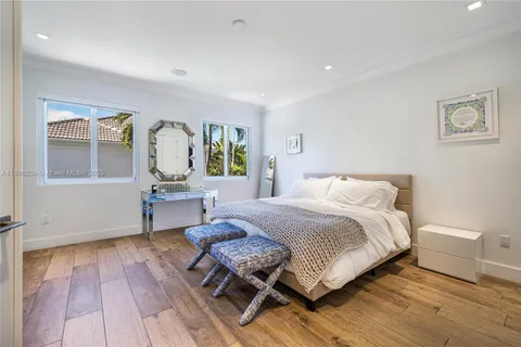 a bedroom with a bed tv and window