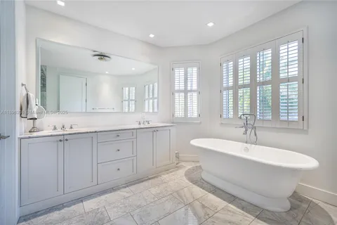 a bathroom with a shower a sink and a mirror