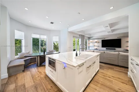 a large white room with a large window and furniture