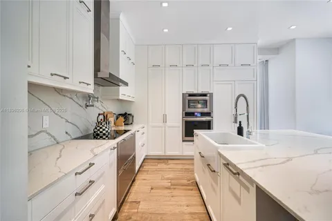 a kitchen with stainless steel appliances granite countertop a sink and cabinets