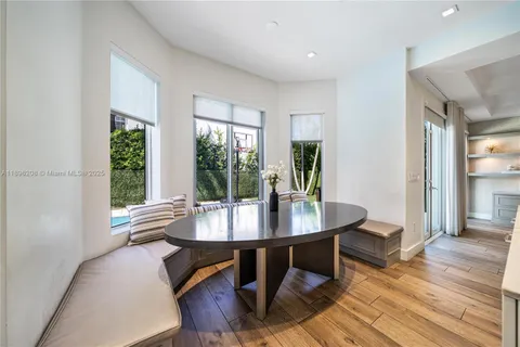 a dining room with furniture and wooden floor