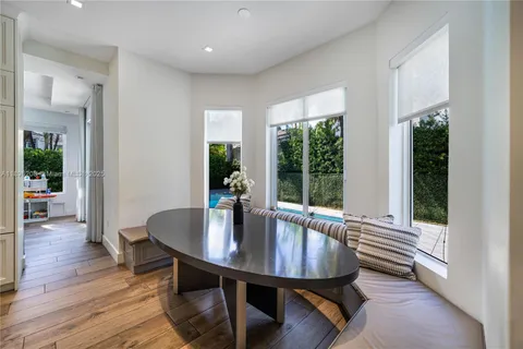 a dining room with furniture and wooden floor