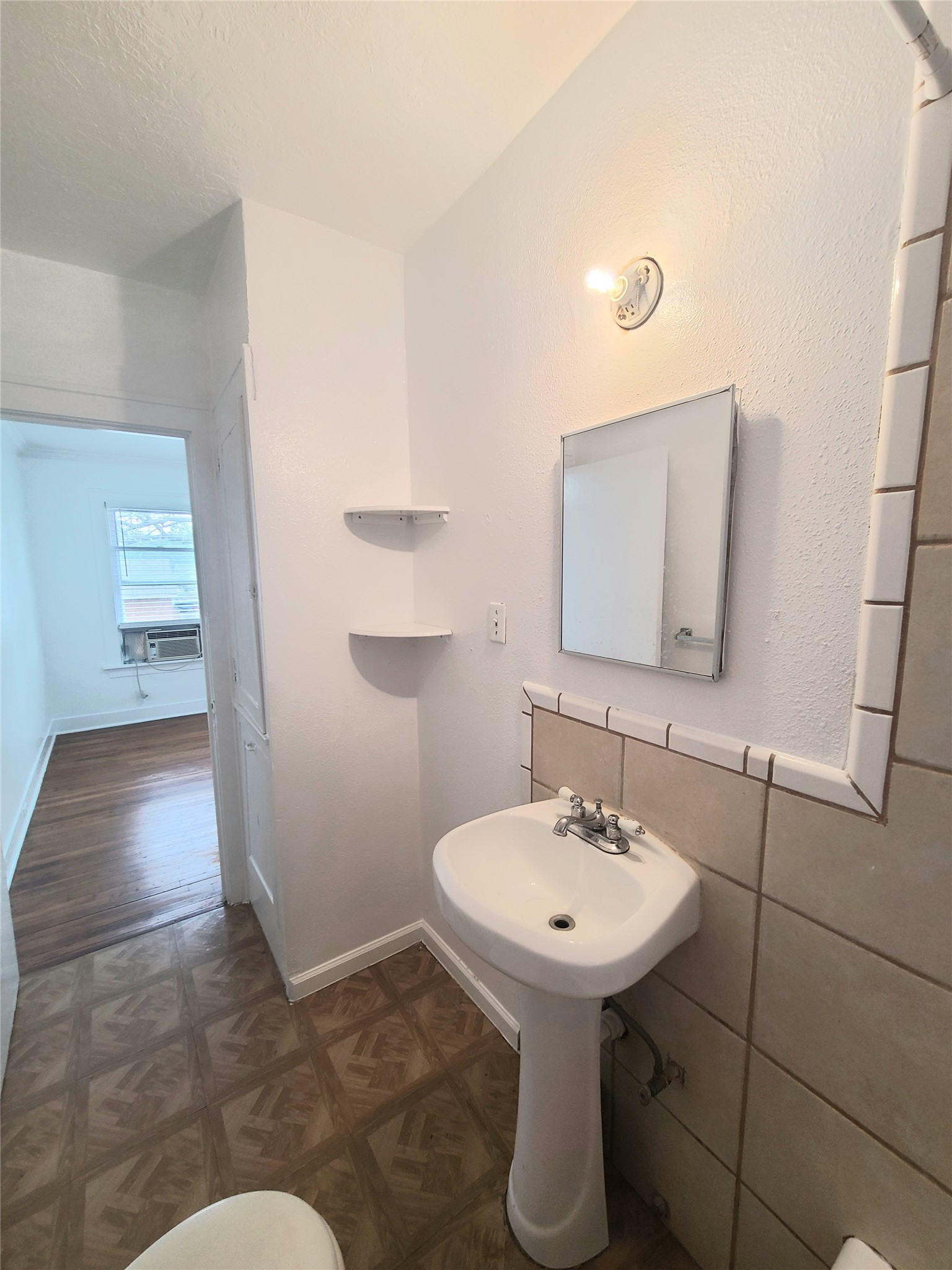 4414 Woodside Street, Unit 8 Houston, TX 77023 - Photo 12 of 14 a bathroom with sink and mirror