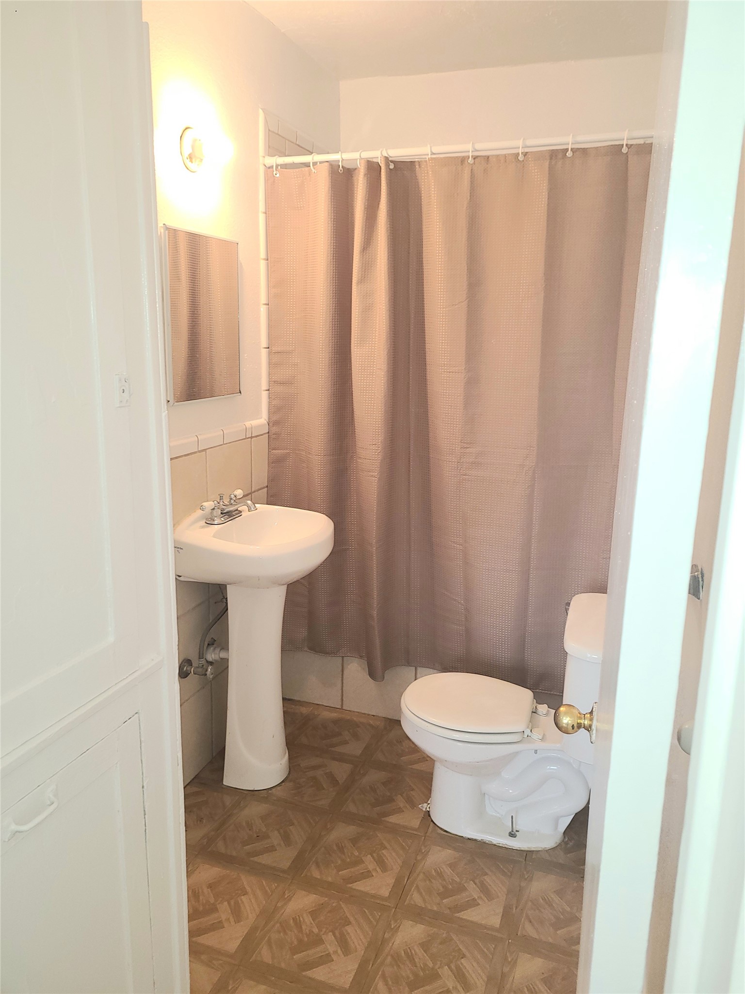 4414 Woodside Street, Unit 8 Houston, TX 77023 - Photo 14 of 14 a bathroom with a sink toilet and a mirror