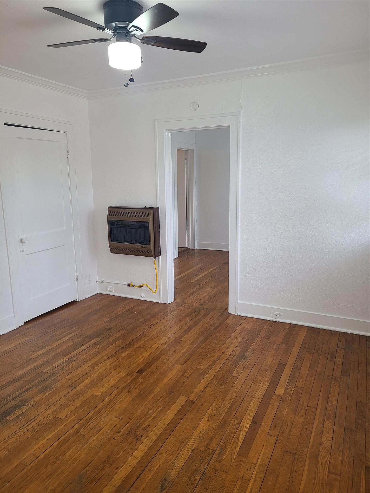 4414 Woodside Street, Unit 8 Houston, TX 77023 - Photo 3 of 14 a view of an empty room with wooden floor and a ceiling fan