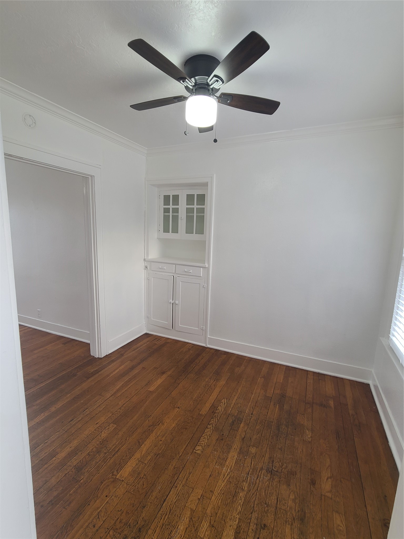 4414 Woodside Street, Unit 8 Houston, TX 77023 - Photo 4 of 14 wooden floor in an empty room with a window