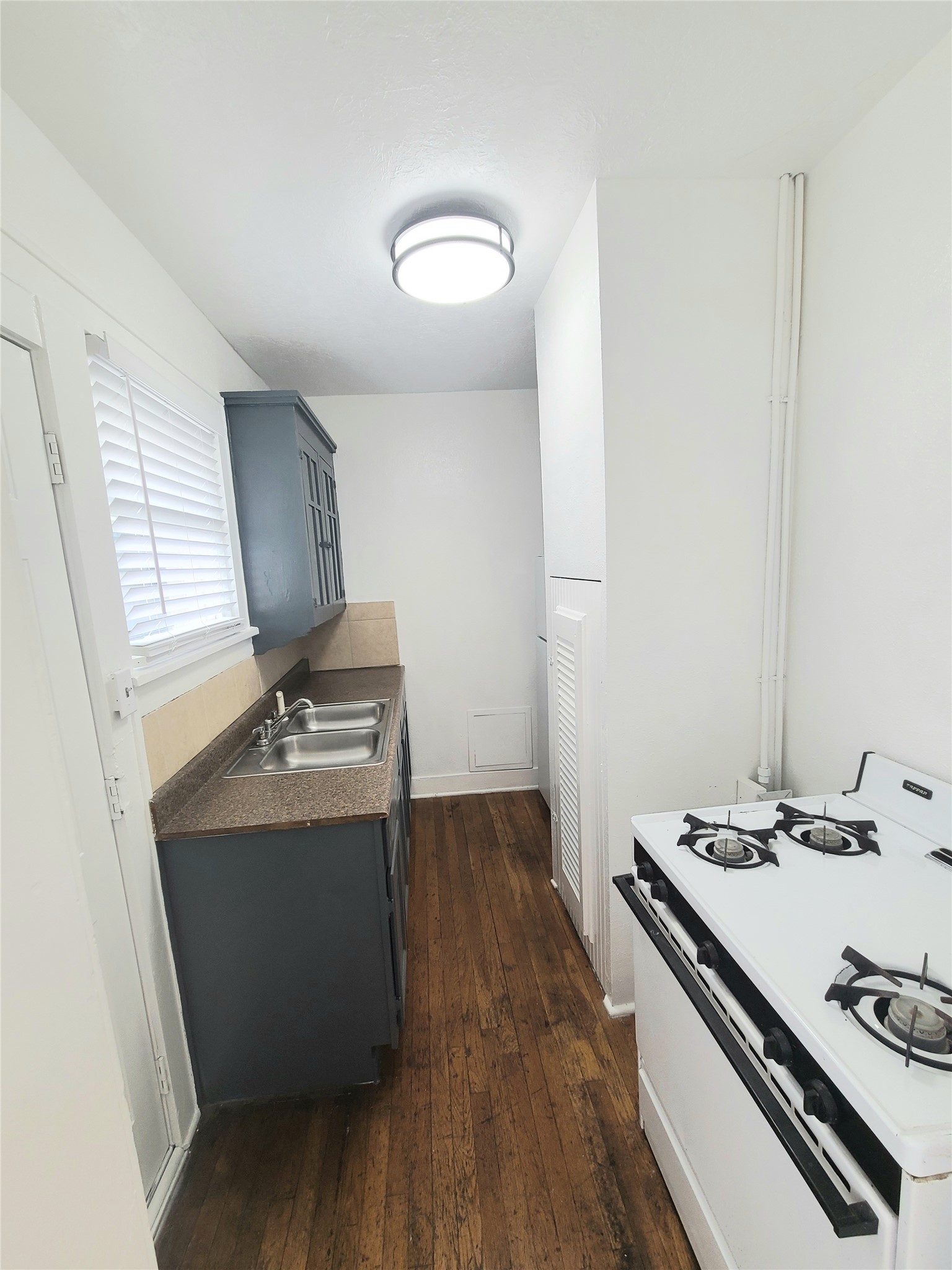 4414 Woodside Street, Unit 8 Houston, TX 77023 - Photo 8 of 14 a view of kitchen island with wooden floor