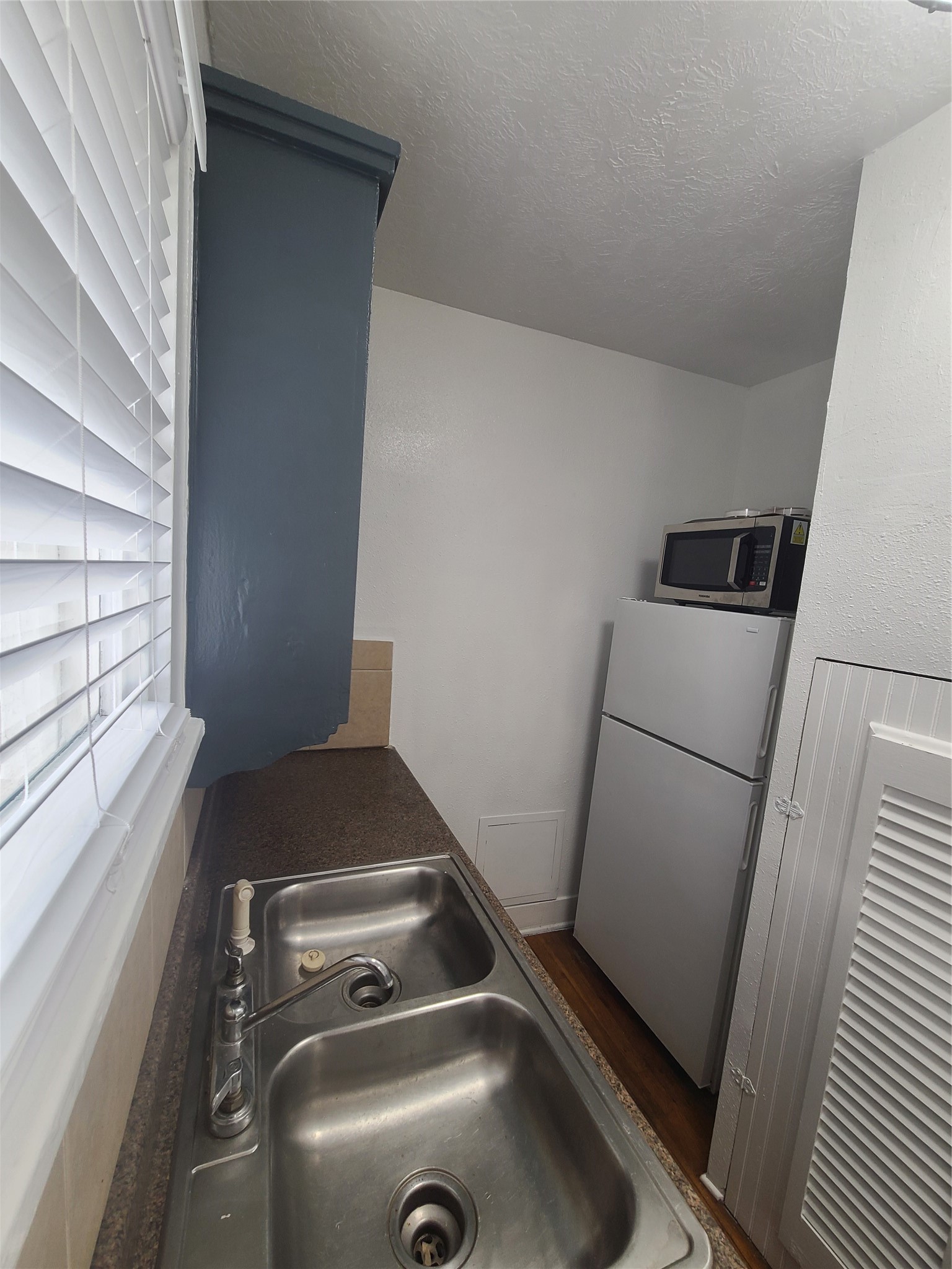 4414 Woodside Street, Unit 8 Houston, TX 77023 - Photo 9 of 14 a view of storage and utility room with washer and dryer